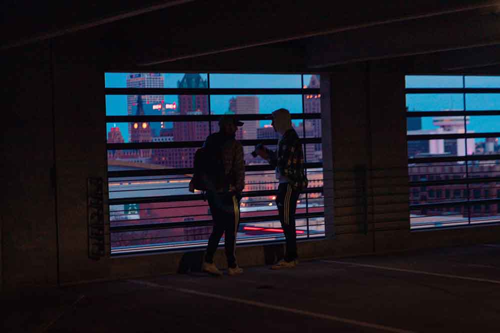 People standing in parking garage.