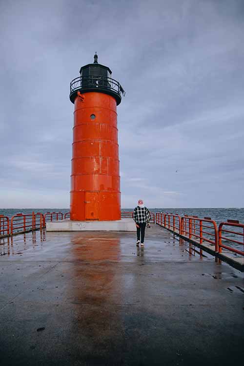 Person walks towards Milwaukee red Lighthouse