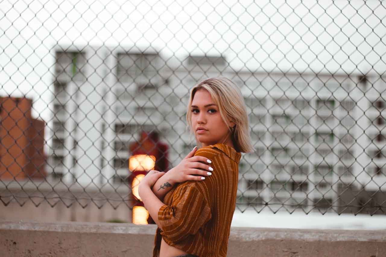 Photoshoot sepia theme with model’s arms crossed