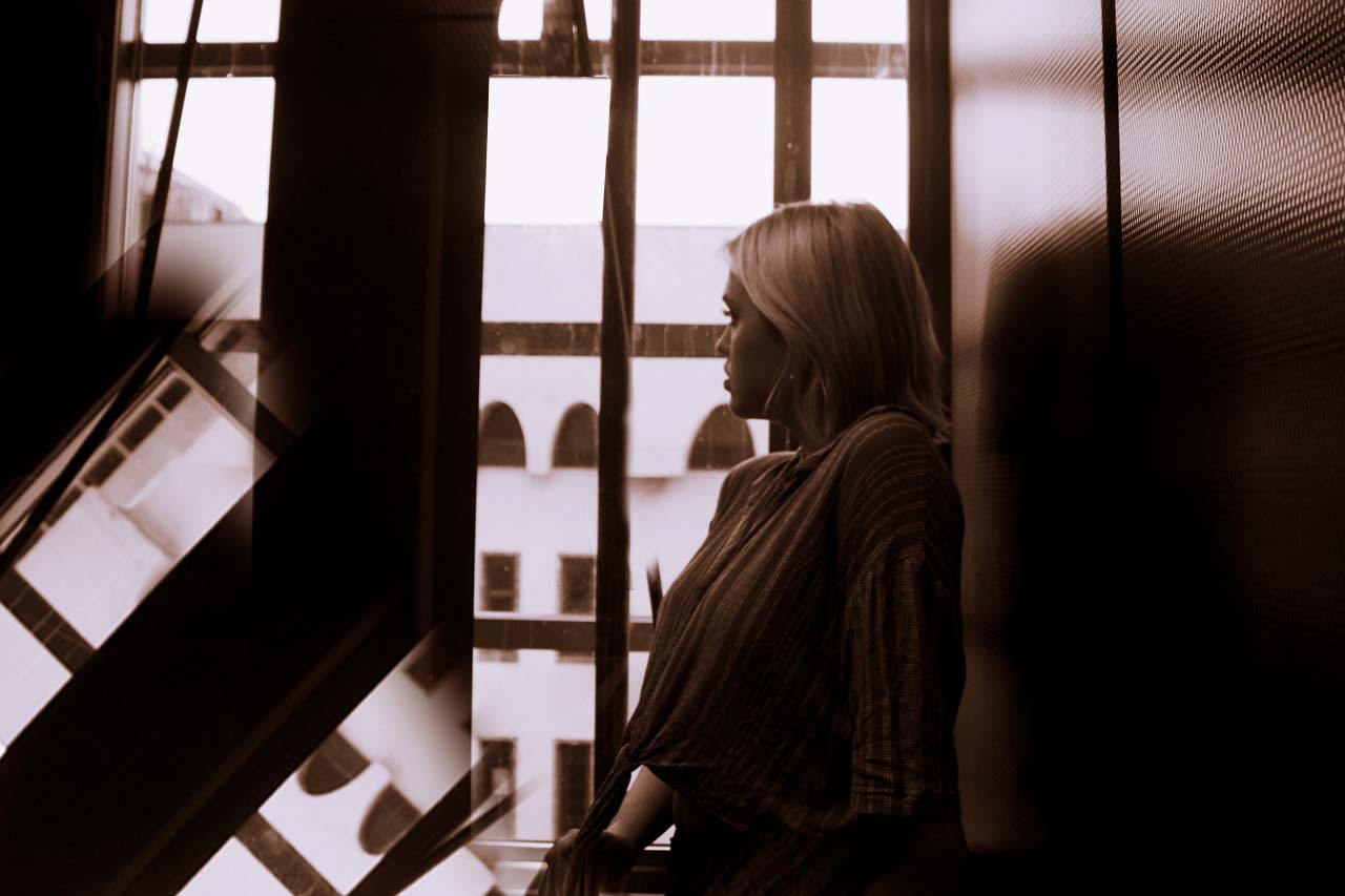 girl model looking at photographer on parking ramp